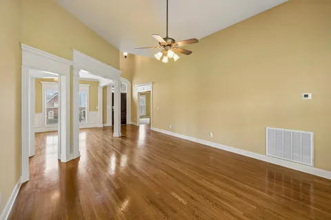 a view of a living room a dining room with wooden floor and a fireplace