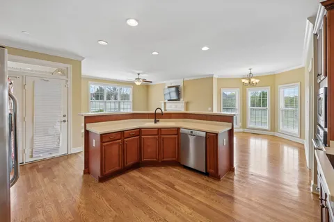a view of an empty room with a window and fireplace