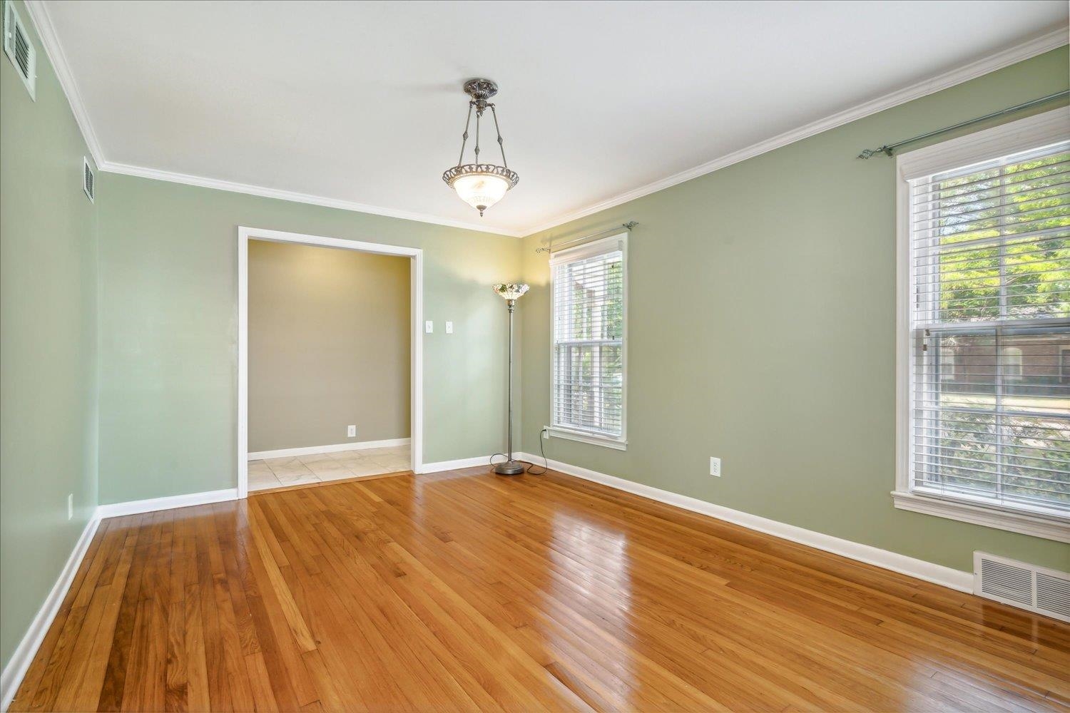 416 Fleda Road Memphis, TN 38120 - Photo 6 of 32 Empty room with light hardwood / wood-style flooring and crown molding