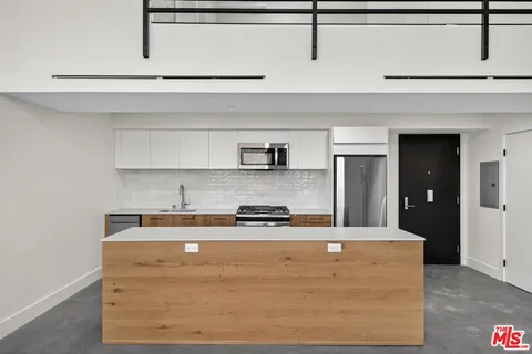 a kitchen with kitchen countertops and cabinets