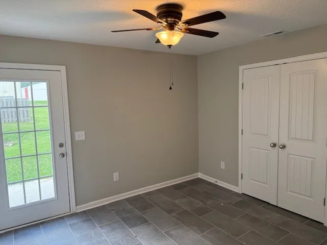 an empty room with closet area
