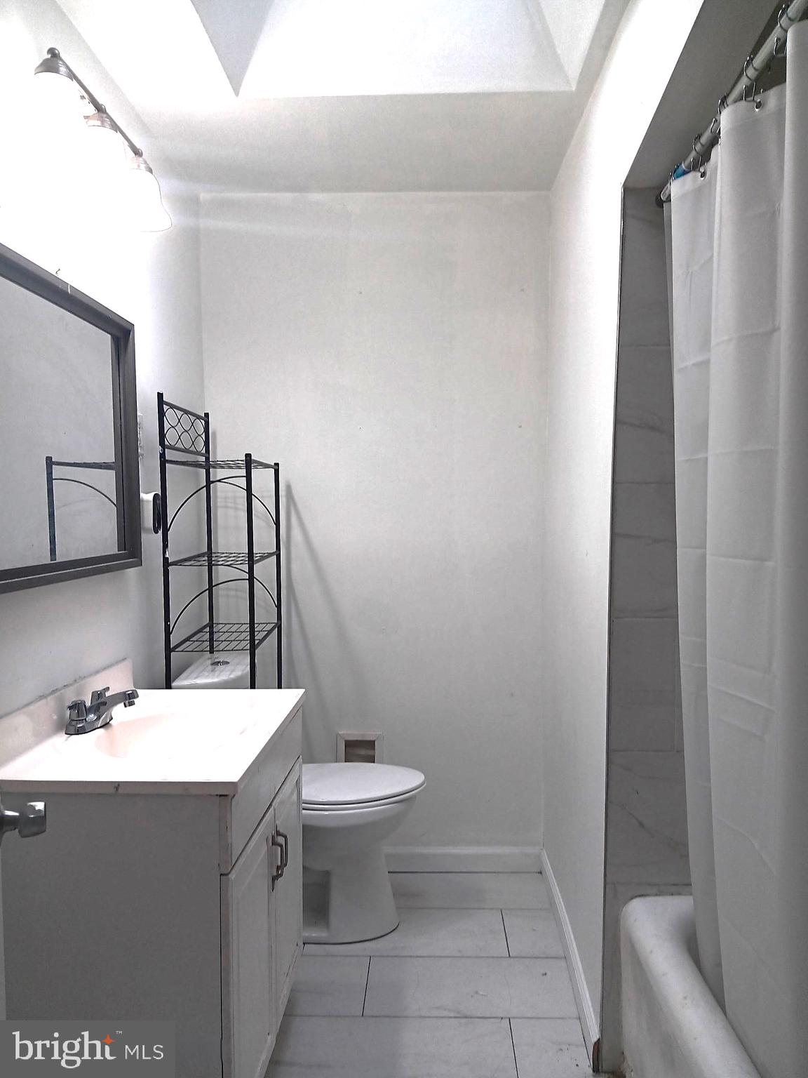 1815 Penfield Street Philadelphia, PA 19126 - Photo 8 of 11 a bathroom with a sink toilet and mirror