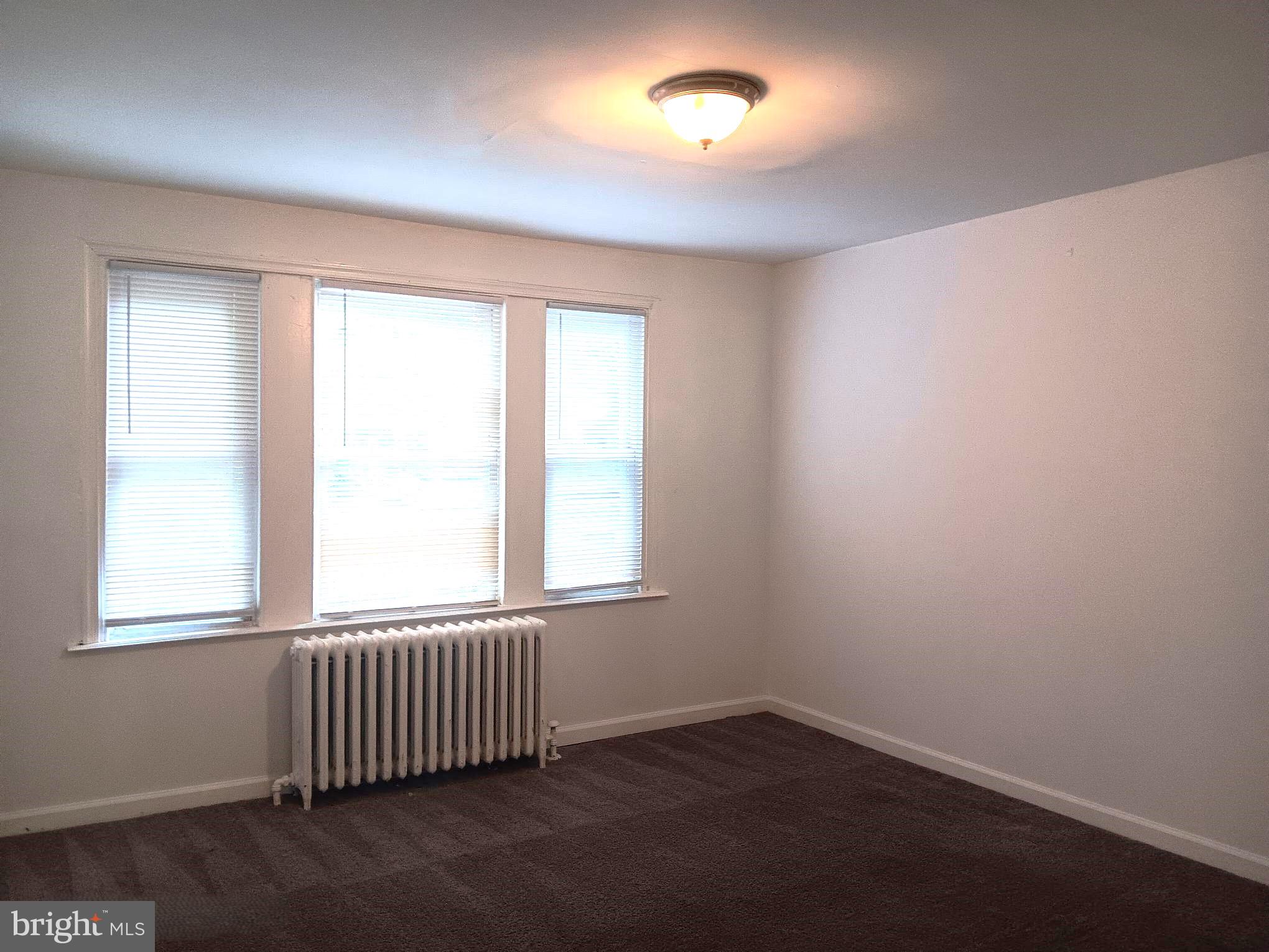 1815 Penfield Street Philadelphia, PA 19126 - Photo 9 of 11 an empty room with wooden floor and windows