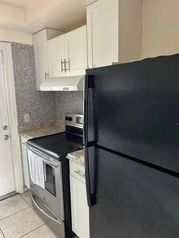 a kitchen with granite countertop cabinets and steel stainless steel appliances