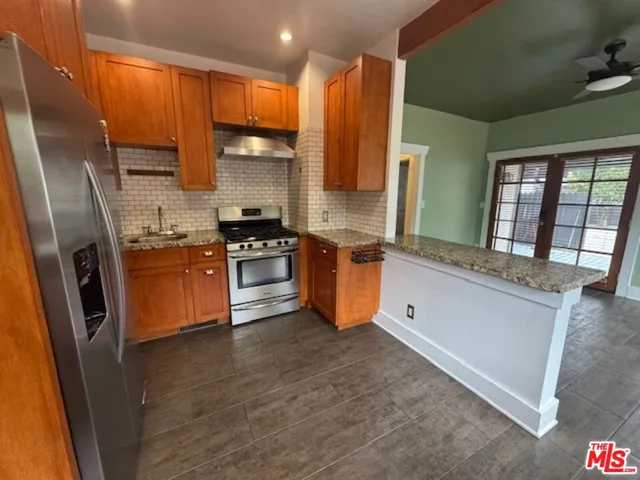 a kitchen with stainless steel appliances a refrigerator sink and cabinets