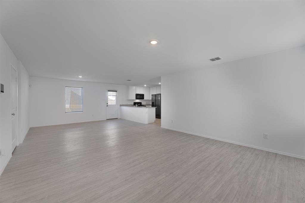 9752 Platteview Road Fort Worth, TX 76179 - Photo 11 of 25 a view of empty room with wooden floor