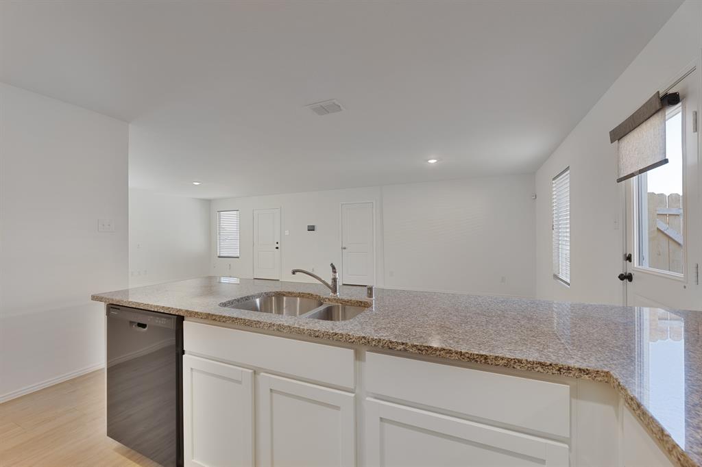 9752 Platteview Road Fort Worth, TX 76179 - Photo 14 of 25 a bathroom with a granite countertop sink and a mirror