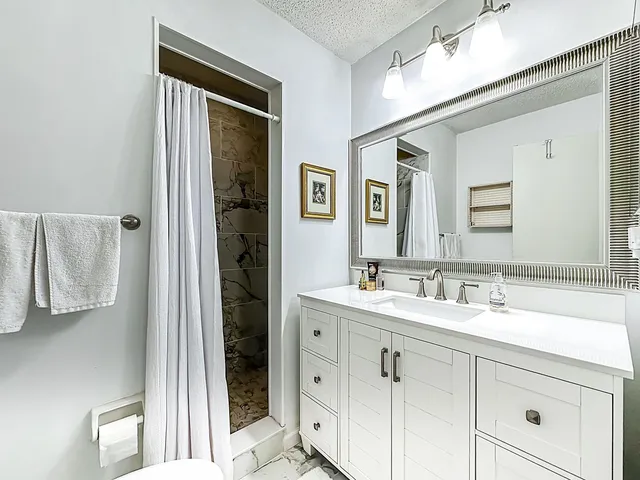 a bathroom with a double vanity sink and a mirror
