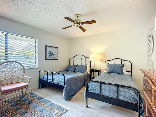 a bedroom with a bed a couch and a window