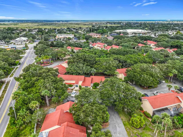an aerial view of residential houses with outdoor space and street view