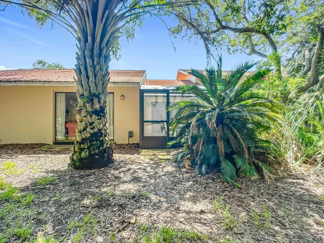 a view of a house with a tree