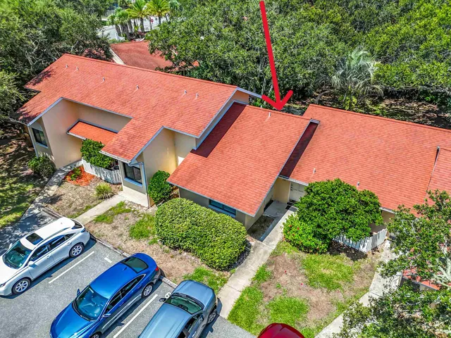 an aerial view of a house with a yard and outdoor seating