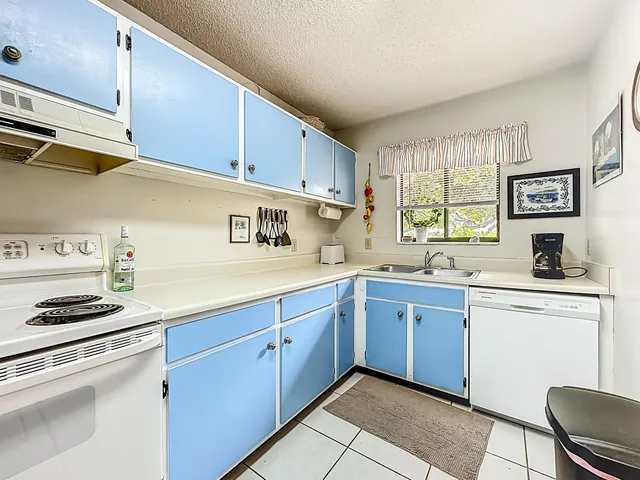 a kitchen with stainless steel appliances granite countertop a sink and cabinets