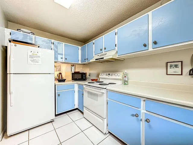 a kitchen with stainless steel appliances granite countertop white refrigerator stove a sink and dishwasher