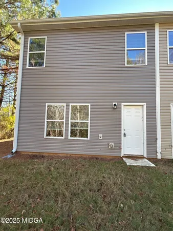 a view of a house with a small yard