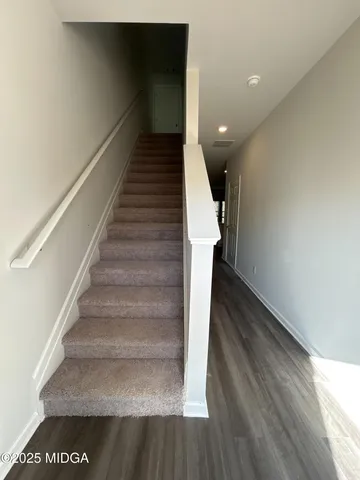 a view of entryway and hall with wooden floor