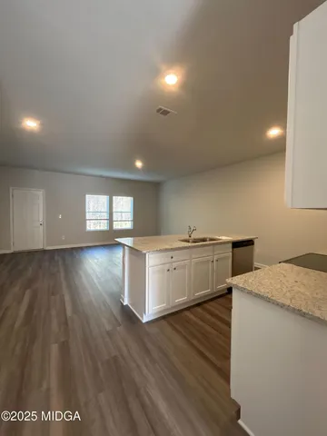 a kitchen with a wooden floor and white appliances