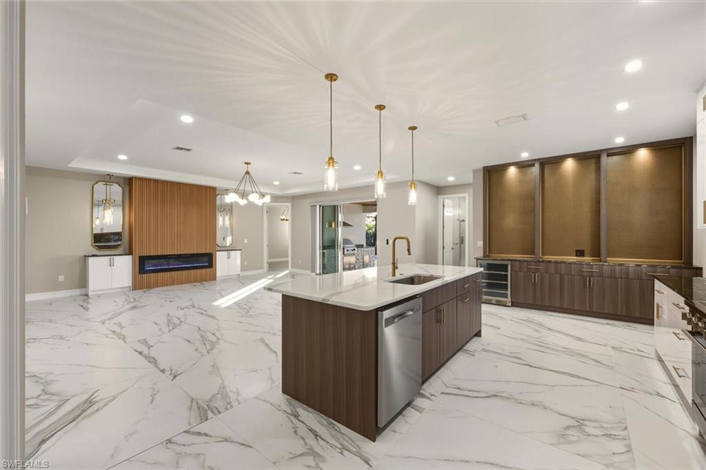 28049 Captiva Shell Loop Bonita Springs, FL 34135 - Photo 50 of 50 a large kitchen with kitchen island a sink a counter top stainless steel appliances and cabinets