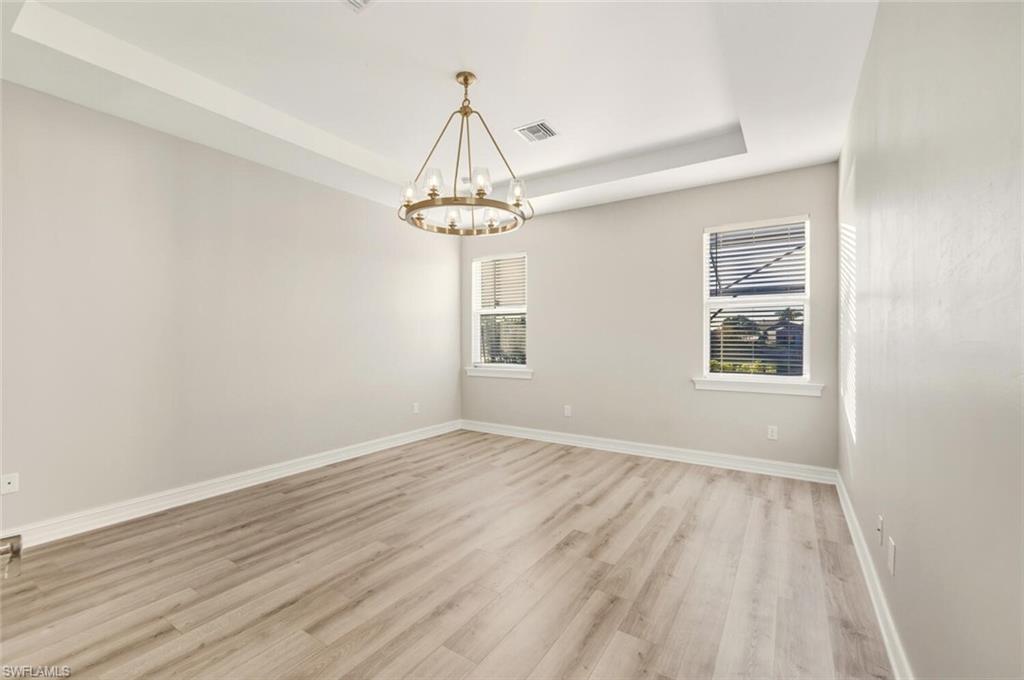 28049 Captiva Shell Loop Bonita Springs, FL 34135 - Photo 14 of 50 a view of empty room with wooden floor and window