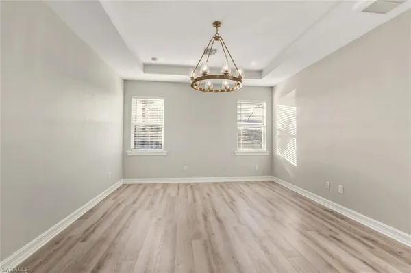 a kitchen with stainless steel appliances kitchen island granite countertop a refrigerator a oven a sink and a kitchen island