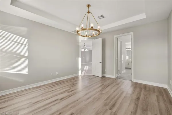 a large kitchen with kitchen island a sink a counter top stainless steel appliances and cabinets