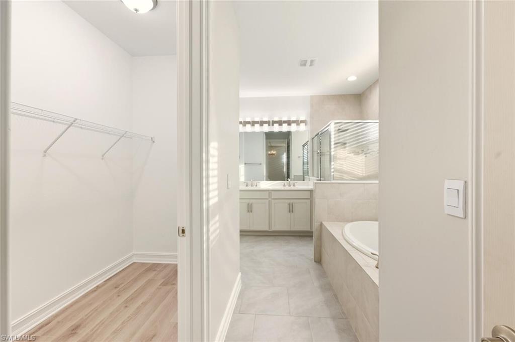 28049 Captiva Shell Loop Bonita Springs, FL 34135 - Photo 17 of 50 a bathroom with a toilet sink and mirror