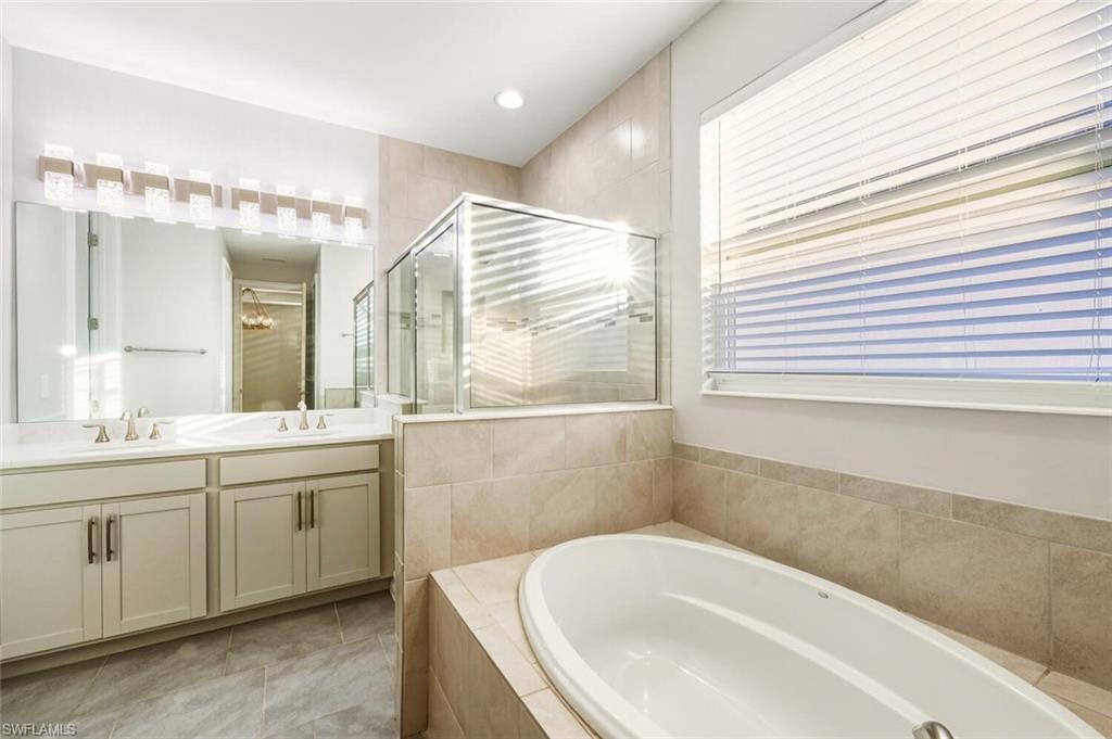 28049 Captiva Shell Loop Bonita Springs, FL 34135 - Photo 18 of 50 a bathroom with a bathtub and a sink