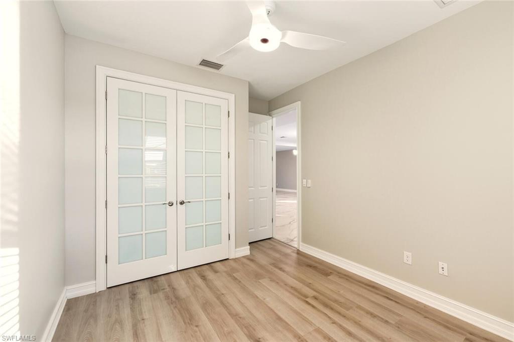28049 Captiva Shell Loop Bonita Springs, FL 34135 - Photo 22 of 50 an empty room with wooden floor