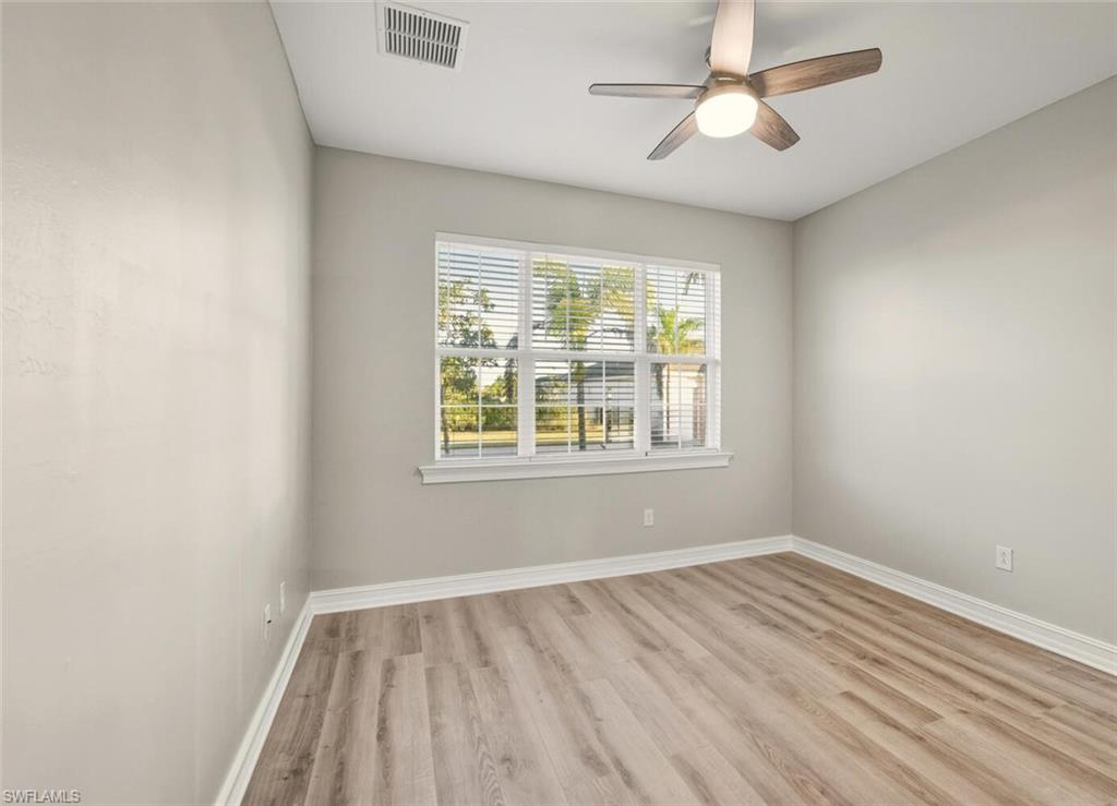 28049 Captiva Shell Loop Bonita Springs, FL 34135 - Photo 24 of 50 wooden floor in an empty room with a window