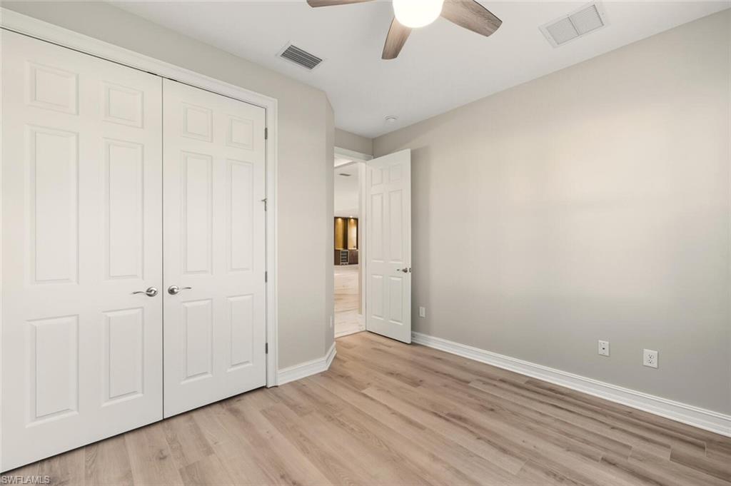 28049 Captiva Shell Loop Bonita Springs, FL 34135 - Photo 25 of 50 an empty room with a hardwood and ceiling fan