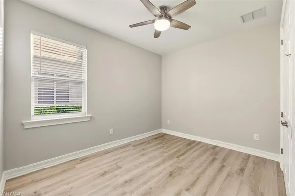 an empty room with wooden floor