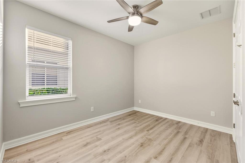 28049 Captiva Shell Loop Bonita Springs, FL 34135 - Photo 26 of 50 a view of empty room with wooden floor and fan