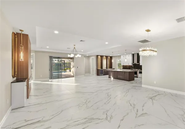 a large bathroom with a tub and a large mirror