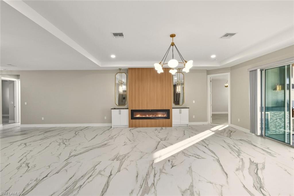28049 Captiva Shell Loop Bonita Springs, FL 34135 - Photo 47 of 50 a spacious bathroom with a chandelier a mirror and a shower
