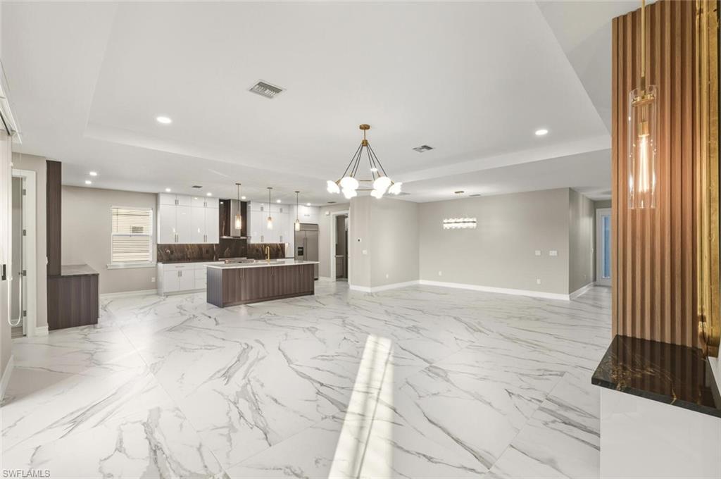 28049 Captiva Shell Loop Bonita Springs, FL 34135 - Photo 48 of 50 a view of a kitchen with a sink and a chandelier