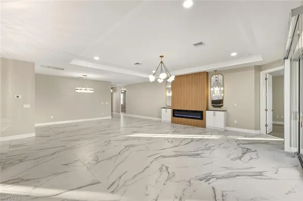 a spacious bathroom with a chandelier a mirror and a shower