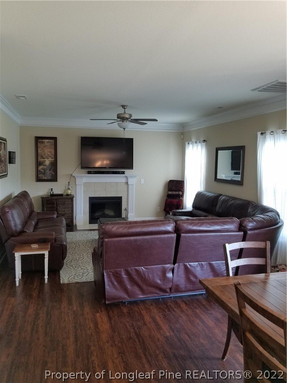 3720 Thrower Road Hope Mills, NC 28348 - Photo 7 of 26 a living room with furniture a flat screen tv and a fireplace