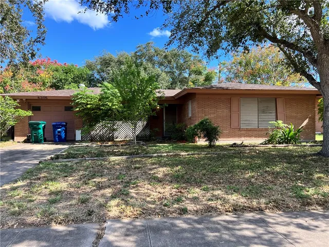 a view of a house with yard and a garden