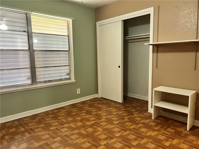 a view of a room with a window and a ceiling fan