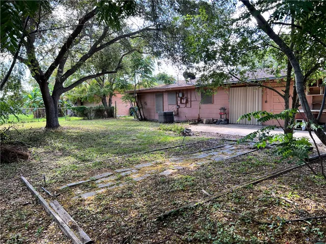a house that has a tree in front of it
