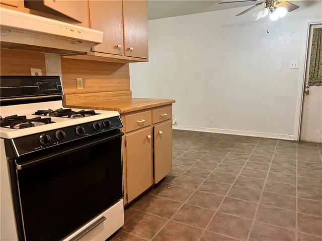 a stove top oven sitting inside of a kitchen