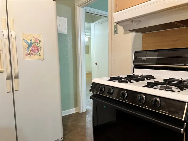 a kitchen with a stove and a refrigerator