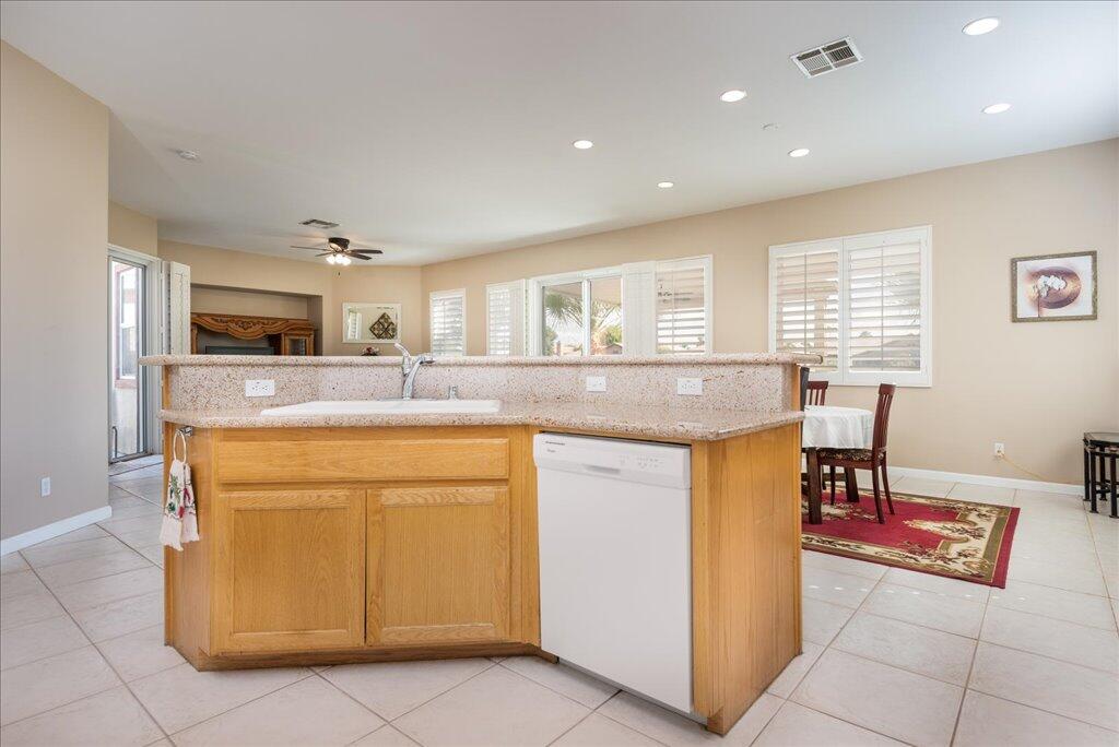 49562 Wayne Street Indio, CA 92201 - Photo 12 of 52 a kitchen with granite countertop cabinets and chair