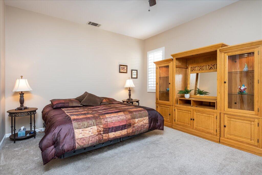 49562 Wayne Street Indio, CA 92201 - Photo 24 of 52 a spacious bedroom with a bed and a cabinets