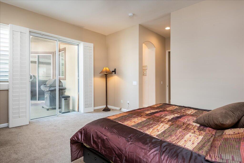 49562 Wayne Street Indio, CA 92201 - Photo 25 of 52 a bedroom with a large bed and a chandelier