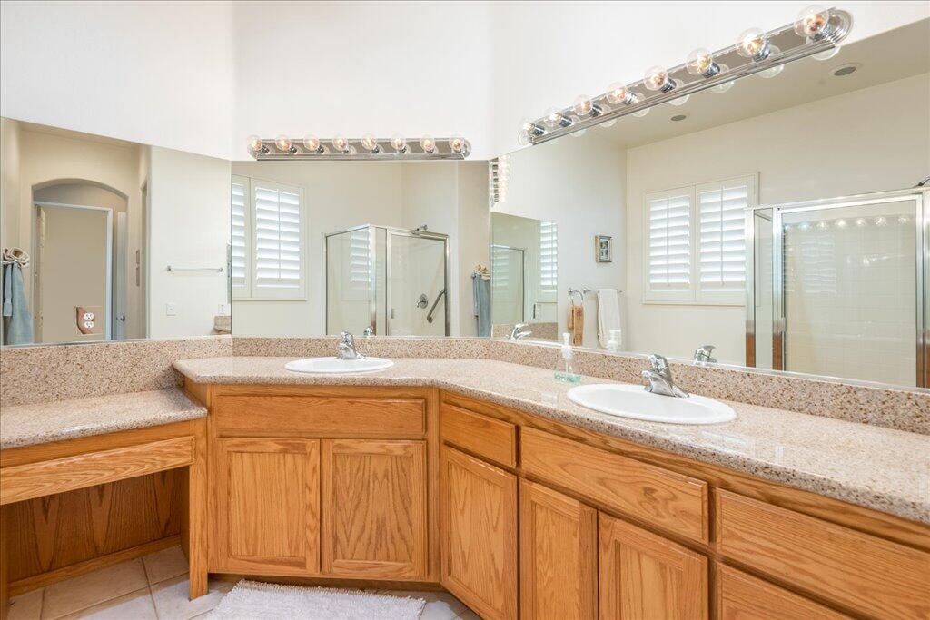 49562 Wayne Street Indio, CA 92201 - Photo 29 of 52 a spacious bathroom with a granite countertop sink and a mirror