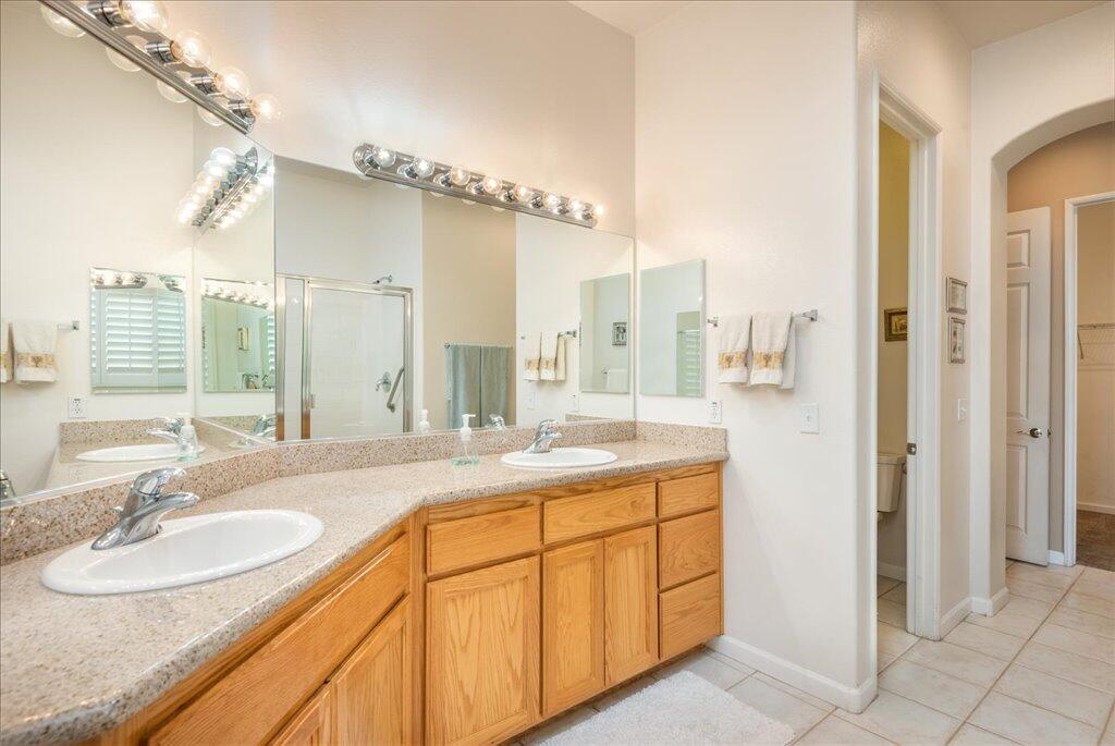 49562 Wayne Street Indio, CA 92201 - Photo 30 of 52 a bathroom with a granite countertop sink and a mirror