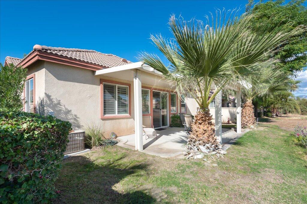 49562 Wayne Street Indio, CA 92201 - Photo 31 of 52 a front view of a house with garden
