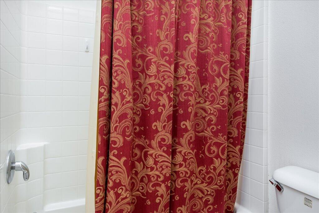 49562 Wayne Street Indio, CA 92201 - Photo 39 of 52 a bathroom with a shower curtain and a toilet