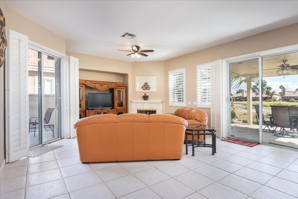 49562 Wayne Street Indio, CA 92201 - Photo 5 of 52 a living room with furniture a flat screen tv and a large window